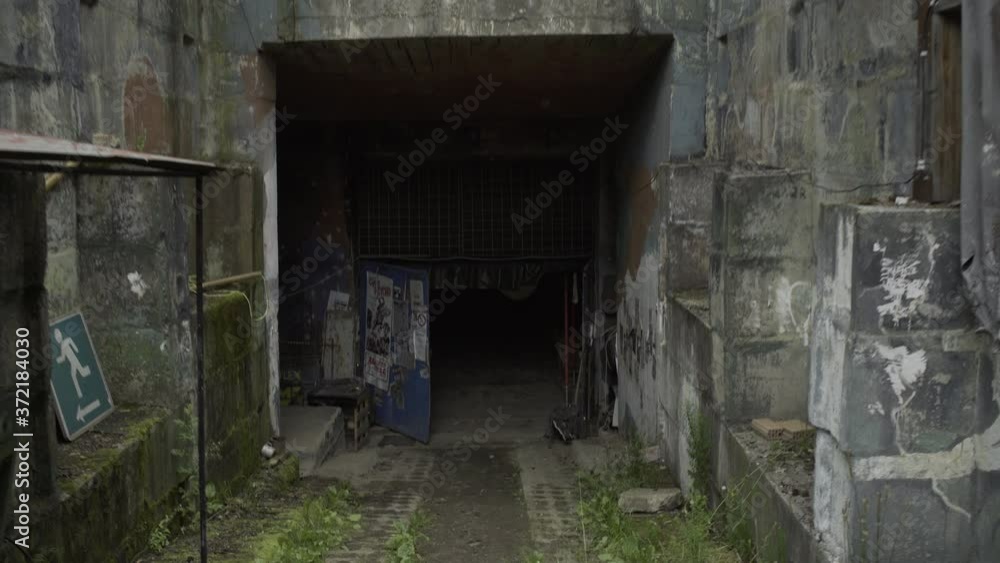 Old rocket base entrance Wide tilt down moving shot Old rocket base entrance Wide tilt down moving shot