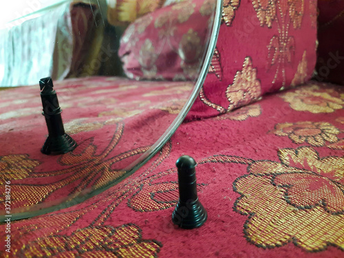 Chess pawn with reflection of a king.