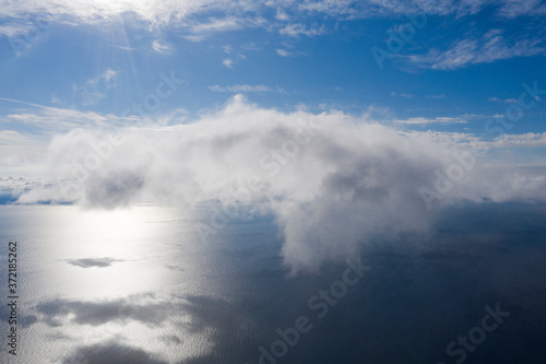 Aerial view small clouds over the sea. View from drone. Aerial top view cloudscape. Texture of clouds. View from above. Sunrise or sunset over clouds. Aerial ocean background
