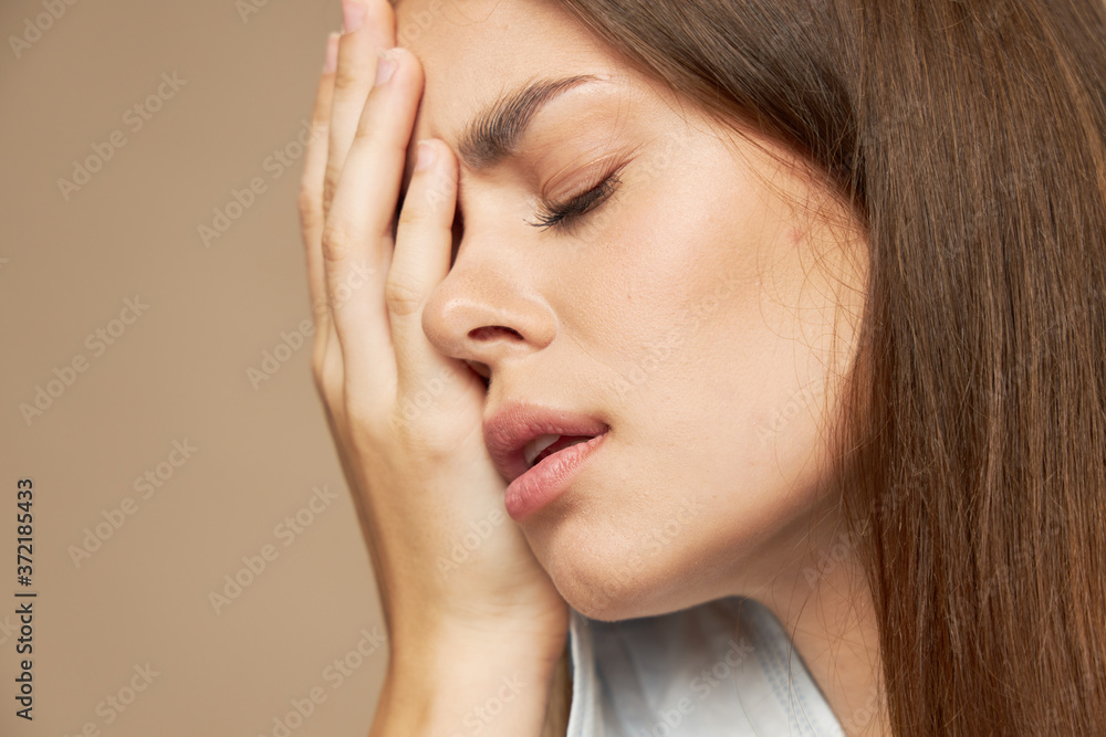 Sad woman with medical mask covered her face with her hand Sad woman with medical mask covered her face with her hand
