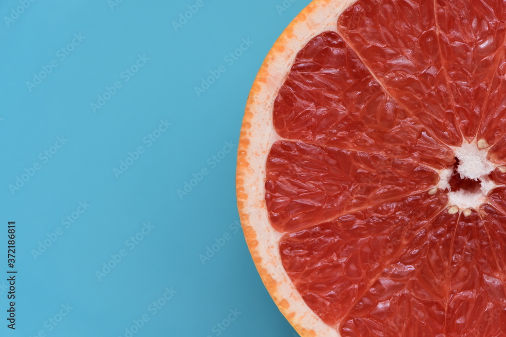Fresh ruby red grapefruit isolated on light blue background. Fresh ruby red grapefruit isolated on light blue background.