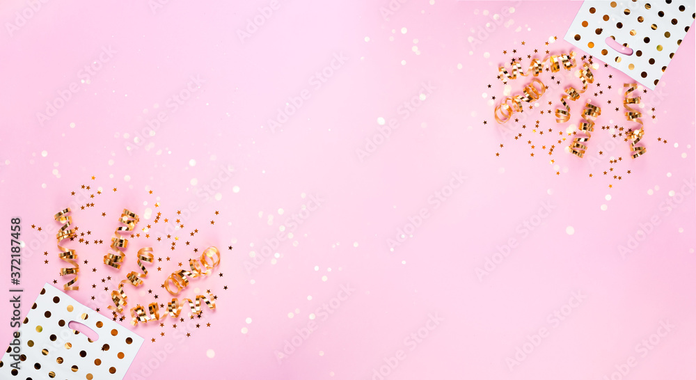 Bag with Confetti, presents and bows,Top horizontal view. New Year 2021 and Christmas festive background. Holidays,shopping and sales concept. Bag with Confetti, presents and bows,Top horizontal view. New Year 2021 and Christmas festive background. Holidays,shopping and sales concept.