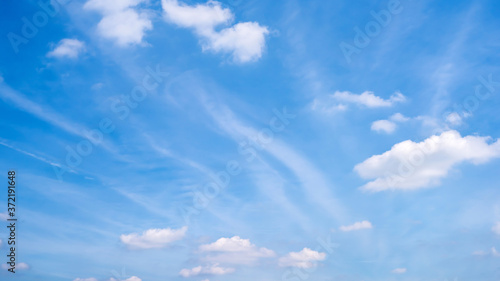Beautiful blue sky with fluffy clouds as a background