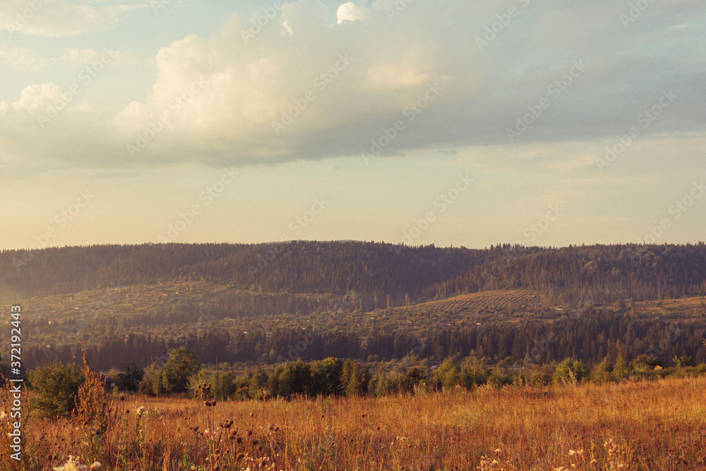 Russia. Travel across Russia. Hills, mountains and fields. Panorama at sunset.