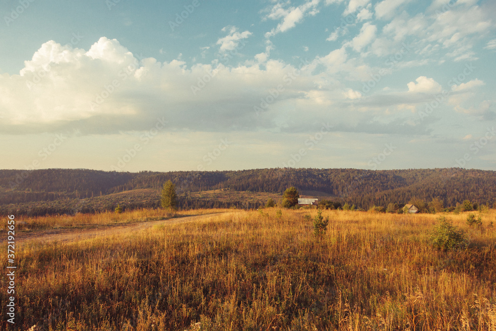 Fototapeta premium Russia. Travel across Russia. Hills, mountains and fields. Panorama at sunset.