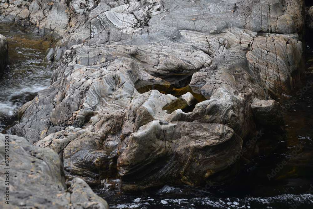 Eroded rocks besides a waterfall at Loch Arkraig the Scottish Highlands Eroded rocks besides a waterfall at Loch Arkraig the Scottish Highlands