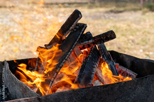 the fire in the grill, burning coals, firewood burn © k_samurkas