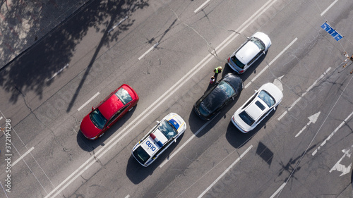 Kyiv  Ukraine - August 18  2020  A police patrol arrives at the road car accident and Police officer listens to road accident participants. Drone Shot.