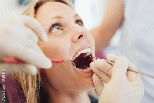 Young woman having her teeth examined