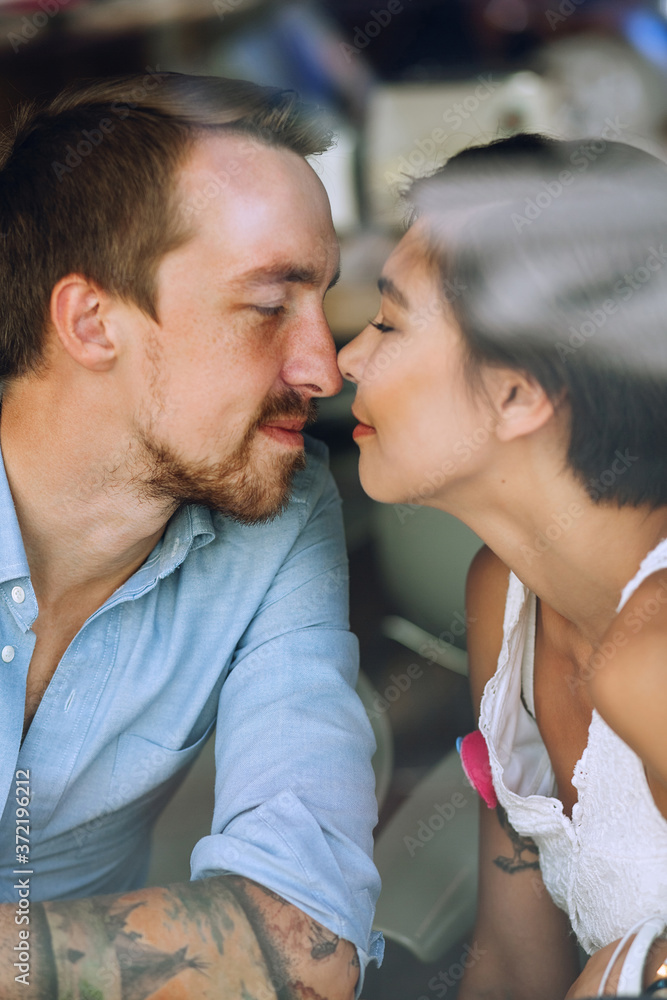 Couple touching noses and going to kiss in cafe Couple touching noses and going to kiss in cafe