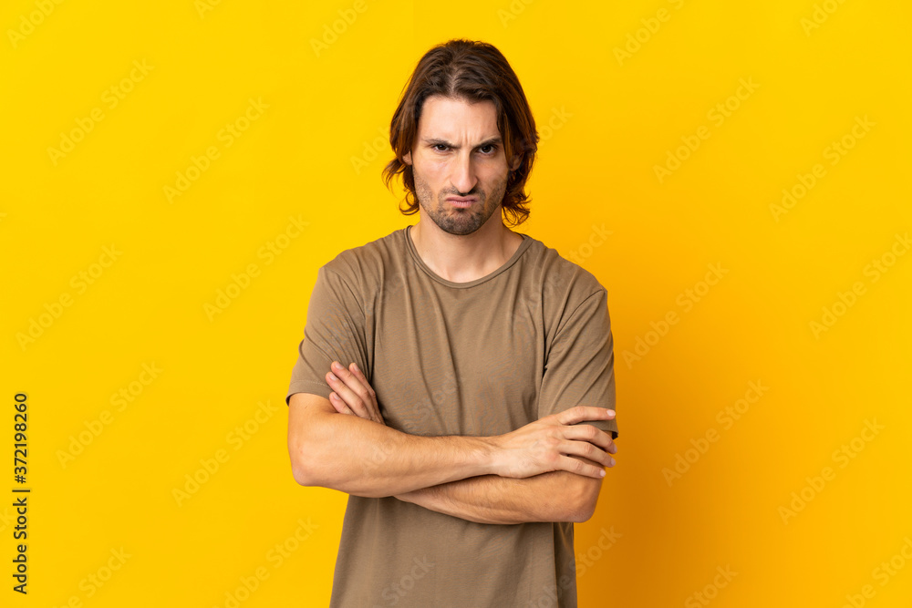 Young handsome man isolated on yellow background feeling upset Young handsome man isolated on yellow background feeling upset