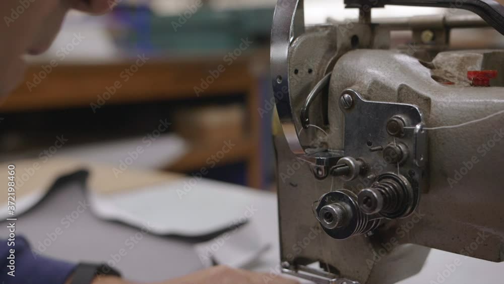 Closeup on a working sewing machine, slowmotion, 1 Closeup on a working sewing machine, slowmotion, 1