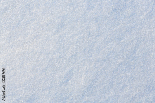 Natural snow texture. Smooth surface of clean fresh snow. Snowy ground. Winter background with snow patterns. Perfect for Christmas and New Year design. Closeup top view. © Andrei Stepanov