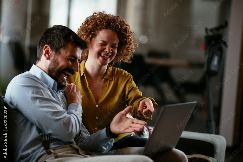 Businesswoman and businessman discussing work in office. Two friends in working together. Businesswoman and businessman discussing work in office. Two friends in working together.