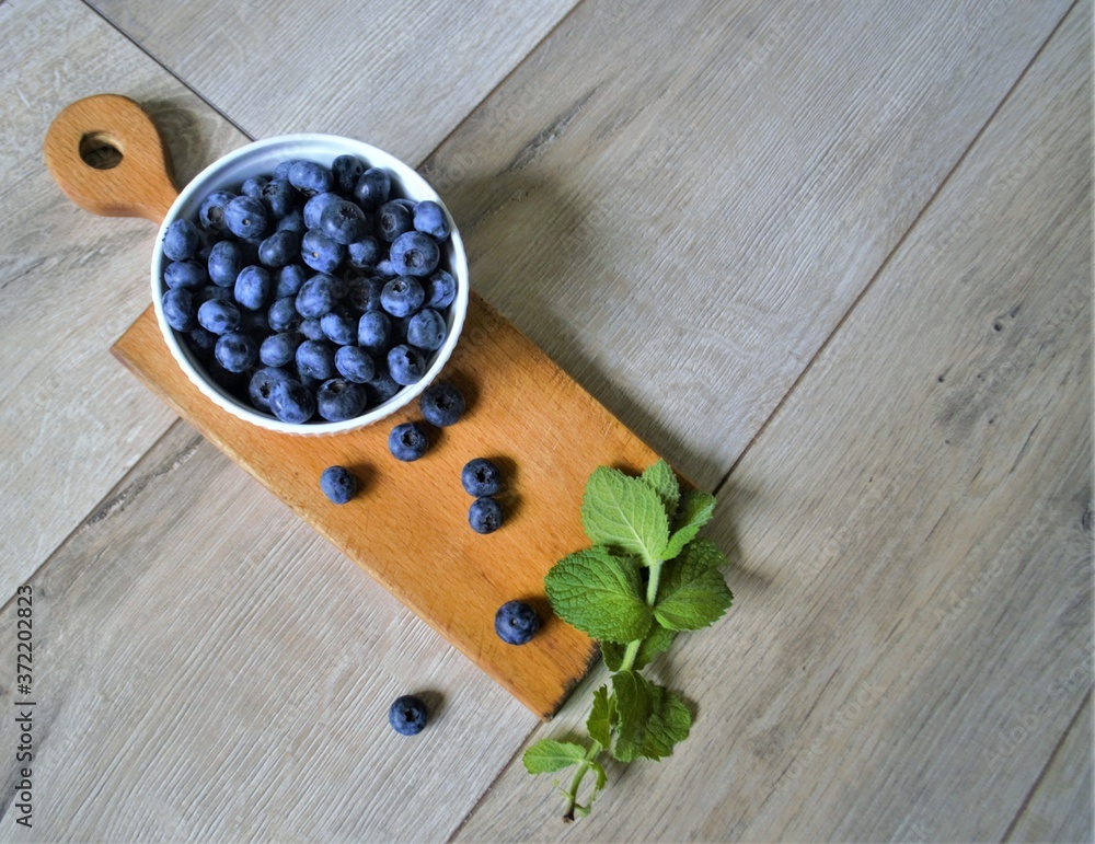 berries on a plate on a board with mint
berries on a plate on a board with mint