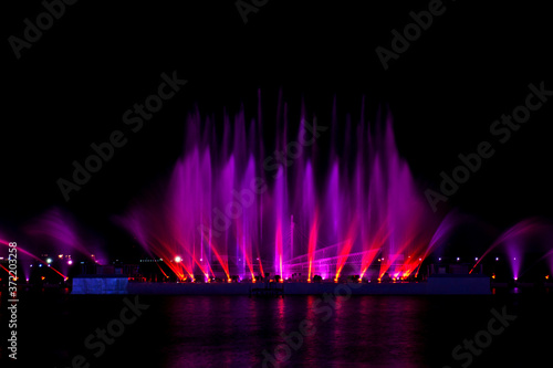 Amazing fantastic colorful fountain with blight at seaside.