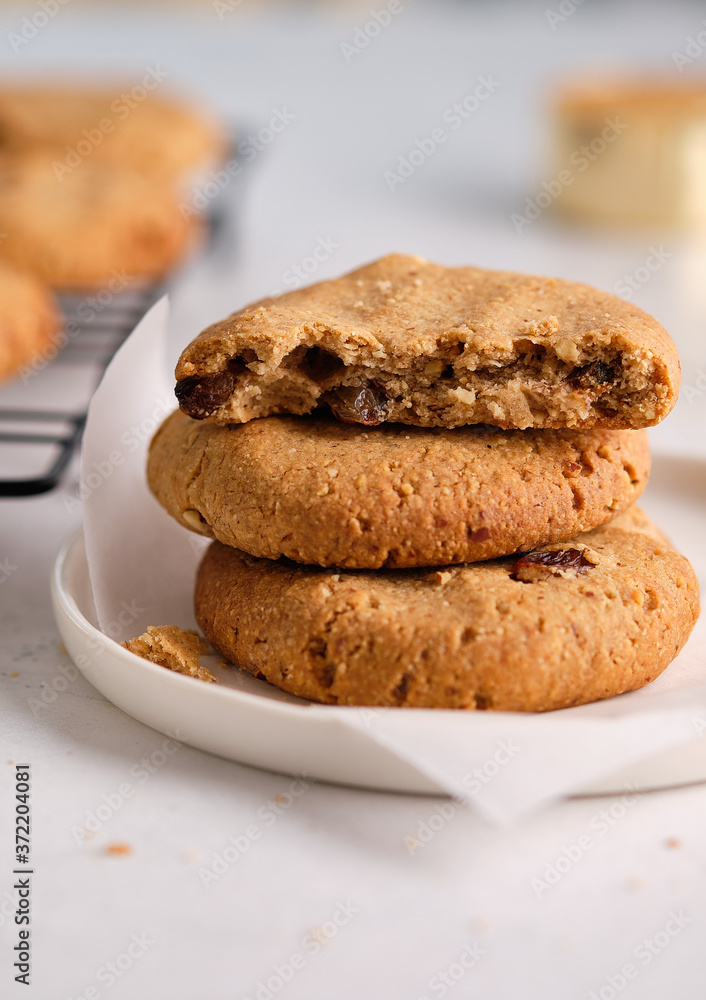 Oatmeal cookies with raisins and nuts on a white background.