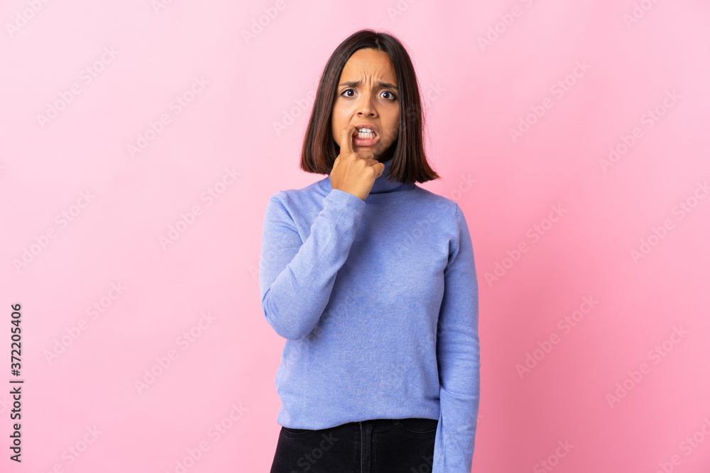 Young latin woman isolated on pink background nervous and scared Young latin woman isolated on pink background nervous and scared