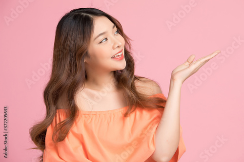 Happy young woman model posing gesture isolated on pink background 