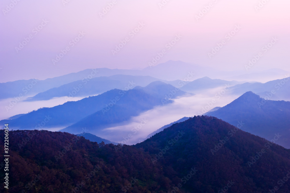 Fototapeta premium The dreaming blue mountainscape with misty and foggy at dawn.