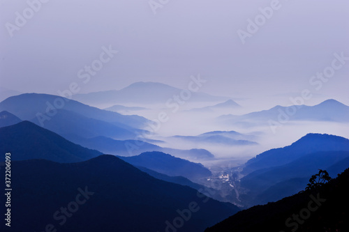 Fototapeta Naklejka Na Ścianę i Meble -  The dreaming blue mountainscape  with misty and foggy at dawn.