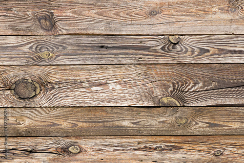 Raw wood texture. Brown wooden wall background. Rustic desks with knots pattern. Countryside architecture wall. Village building construction.