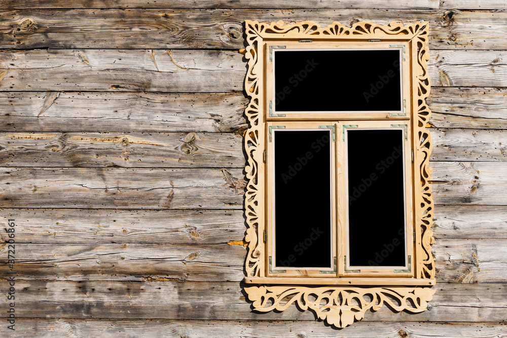 Wooden window background. Empty copy space rustic cottage house. Vintage cabin wall. Countryside architecture texture. Decorative wood carvings. Renovated building made of desks.