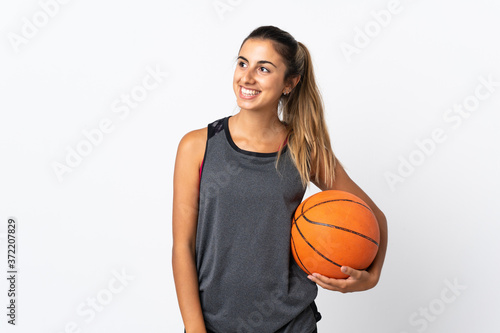 Young hispanic woman playing basketball over isolated white background thinking an idea while looking up