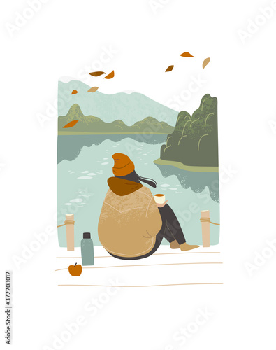 Girl woman sitting outdoors enjoing nature at the bay seashore fjord view at cold autumn weather north nordic sea. Autumn fall melancholy depression mood