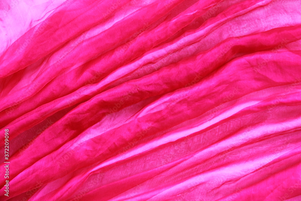 texture of transparent pink fabric with pleats spiral and diagonal