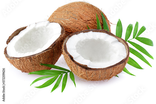 half coconut with green leaves isolated on white background