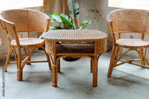 Image of Interior decorative for living area with rattan armchair and plants