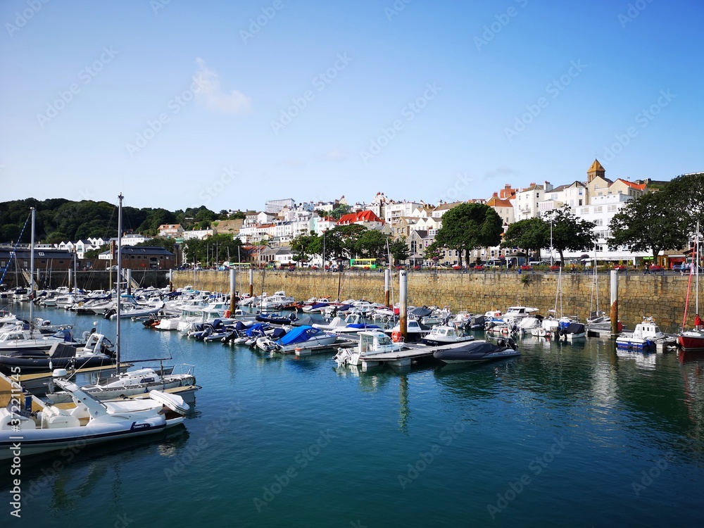 St Peter Port is the capital of Guernsey. Boats moored in the marina on a sunny summer day. 