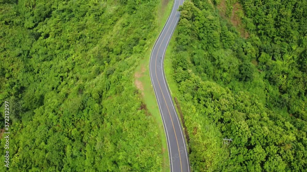 Nan, Thailand. Aerial view of Beautiful sky road over top of mountains with green jungle. Road trip on curve road in mountain. Nan, Thailand. Aerial view of Beautiful sky road over top of mountains with green jungle. Road trip on curve road in mountain.