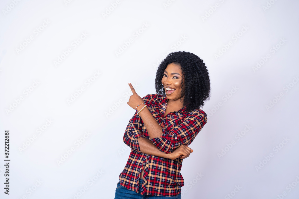 excited pretty black woman smiling and pointing to the copy space on her side excited pretty black woman smiling and pointing to the copy space on her side
