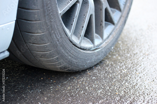Sports car tire on a damp road