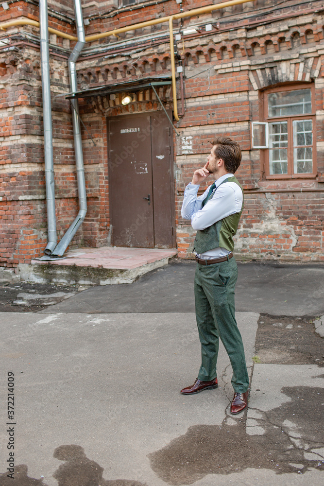 a man stands near a brick house a man stands near a brick house