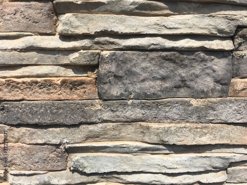 Stone texture  irregularly grey granite stone wall texture and background. 