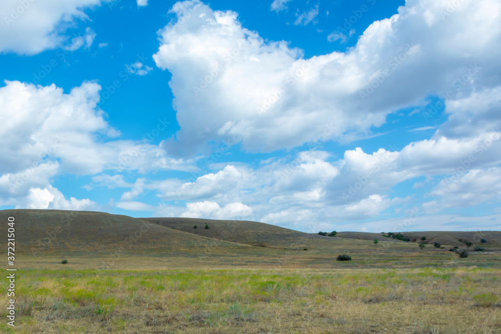 Beautiful landscape. Hills and bright blue sky with white clouds. Summer time concept, nature, selective focus Beautiful landscape. Hills and bright blue sky with white clouds. Summer time concept, nature, selective focus
