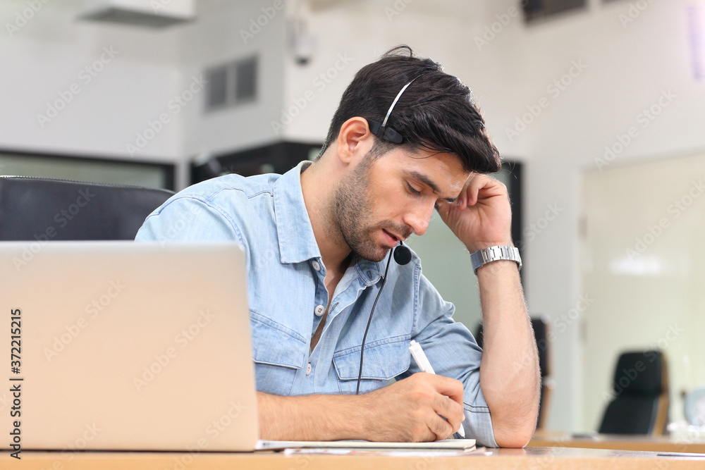 Caucasion businessman IT operator answering online phone call from customer as 24/7 customer service with copy space Caucasion businessman IT operator answering online phone call from customer as 24/7 customer service with copy space