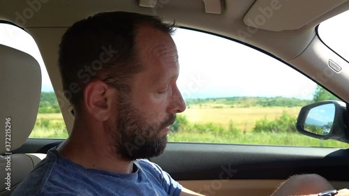 Tired, sleepy man driving car, slow motion
