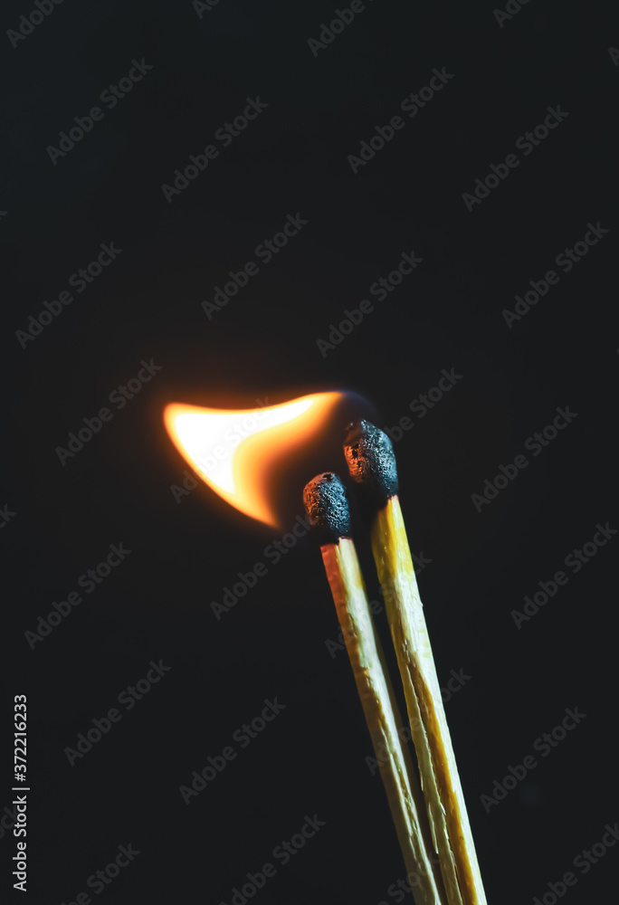Couple of matches burning together with heat flame isolated on a black background. Couple of matches burning together with heat flame isolated on a black background.