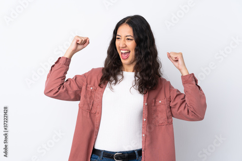 Fényképezés Spanish Chinese woman over isolated white background celebrating a victory