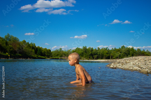  boy bathes in a mountain river