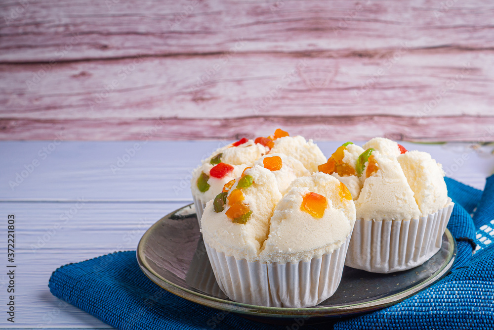 Thai Rice Flour Muffin topped with dry fruit on plate Thai Rice Flour Muffin topped with dry fruit on plate