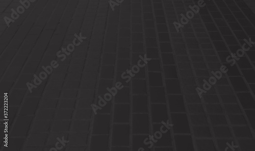 Black concrete paver block floor pattern for background. © Keopaserth