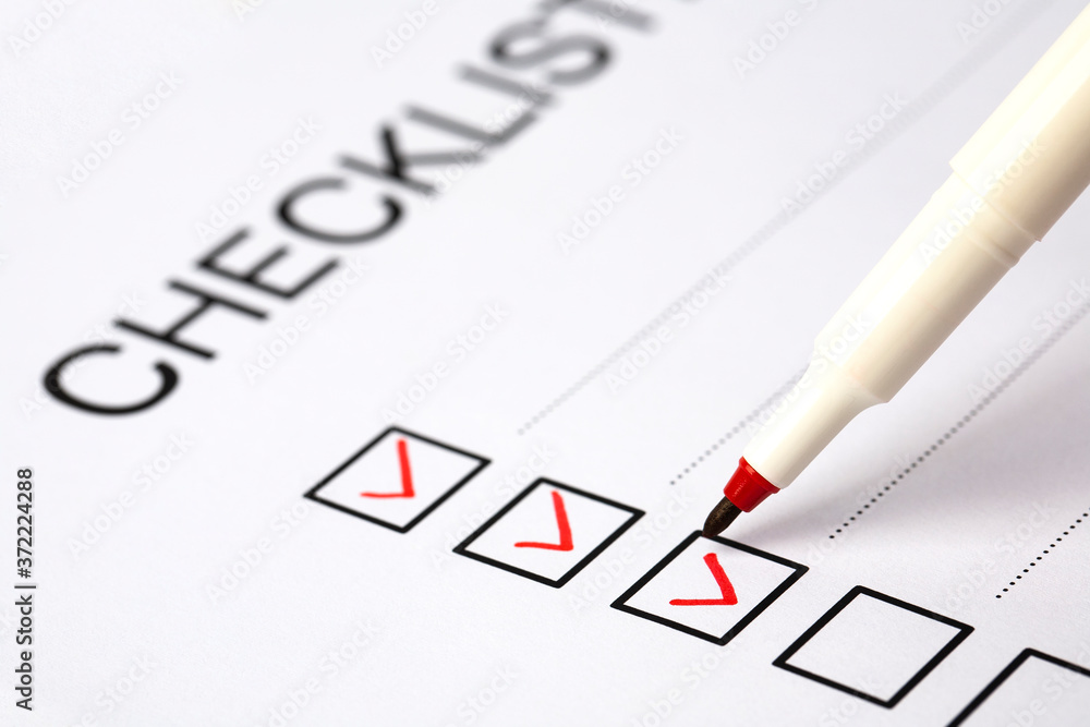 Fototapeta premium red pen marking on checklist box