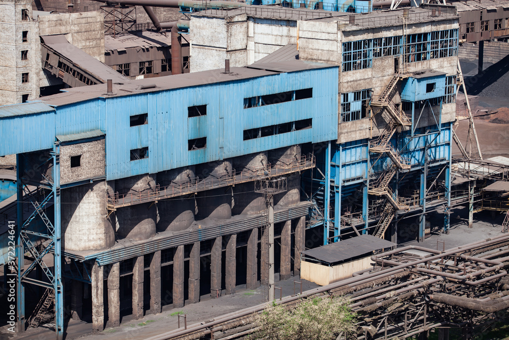 Old soviet unused outdated abandoned blue metallurgy factory building. Taraz city, Kazakhstan.