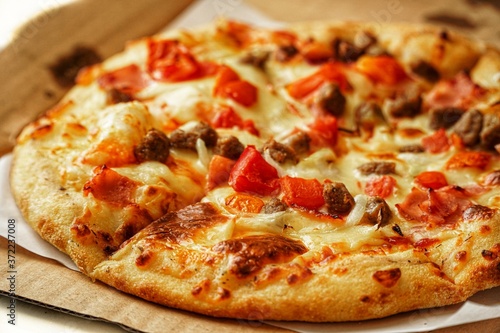 Pizza, close up photo of a delicious pizza with mozzarella cheese, onions, meat, tomato.