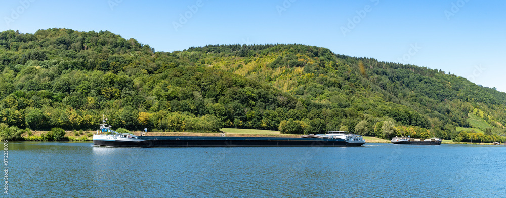 large river barge transporting goods on the Moselle River near Enkirch